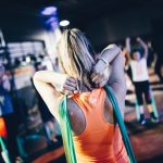 woman holding green rope at her back
